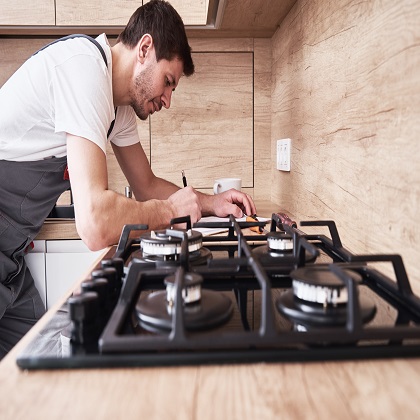 Plumber signs a contract for the services in the kitchen